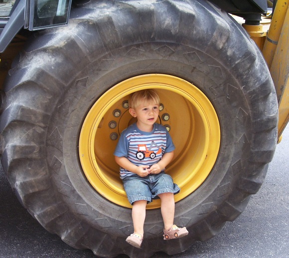Noah Simons, age 2 1/2, of North Scituate investigates a vehicle during the Wheels at Work series at Providence Children's Museum.